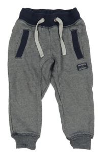 Tmavomodro-bílé pruhované tepláky s nápisem H&M